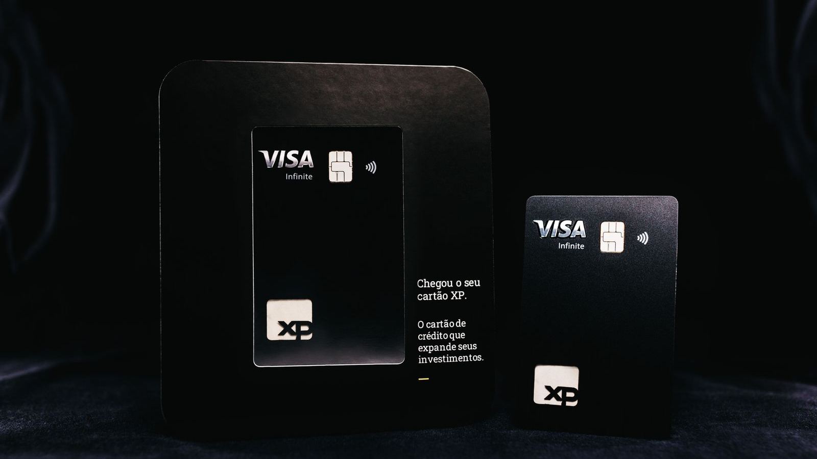 Sleek black bank cards laid out on a dark surface